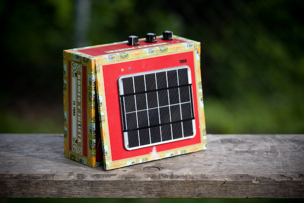 A picture of the solar powered Stella Amp, with the solar panel mostly facing the camera.